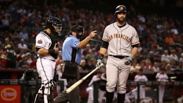 PHOENIX, AZ - APRIL 18: Brandon Belt #9 of the San Francisco Giants reacts after being hit by a pitch during the second inning of the MLB game against the Arizona Diamondbacks at Chase Field on April 18, 2018 in Phoenix, Arizona. (Photo by Christian Petersen/Getty Images)