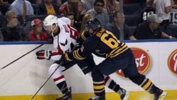 Oct 1, 2014; Buffalo, NY, USA; Buffalo Sabres defenseman Andre Benoit (61) checks Washington Capitals left wing Dane Byers (50) during the third period at First Niagara Center. Buffalo beats Washington 6 to 1. Mandatory Credit: Timothy T. Ludwig-USA TODAY Sports