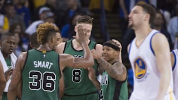 April 1, 2016; Oakland, CA, USA; Boston Celtics guard Isaiah Thomas (4) celebrates with guard Marcus Smart (36) against Golden State Warriors guard Klay Thompson (11, far right) during the fourth quarter at Oracle Arena. The Celtics defeated the Warriors 109-106. Mandatory Credit: Kyle Terada-USA TODAY Sports