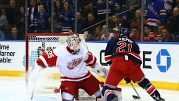 Feb 21, 2016; New York, NY, USA; Detroit Red Wings goaltender Jimmy Howard (35) defends his net against New York Rangers center Derek Stepan (21) during the second period at Madison Square Garden. Mandatory Credit: Andy Marlin-USA TODAY Sports