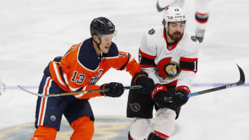 Jan 31, 2021; Edmonton, Alberta, CAN; Edmonton Oilers forward Jesse Puljujarvi (13) and Ottawa Senators forward Nick Paul (13) look for the puck during the third period at Rogers Place. Mandatory Credit: Perry Nelson-USA TODAY Sports