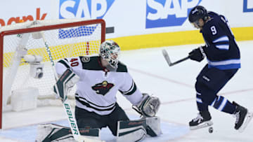 WINNIPEG, MANITOBA - APRIL 11: Devan Dubnyk #40 of the Minnesota Wild follows the puck as Andrew Copp #9 of the Winnipeg Jets screens him in Game One of the Western Conference First Round during the 2018 NHL Stanley Cup Playoffs on April 11, 2018 at Bell MTS Place in Winnipeg, Manitoba, Canada. (Photo by Jason Halstead /Getty Images) *** Local Caption *** Devan Dubnyk; Andrew Copp