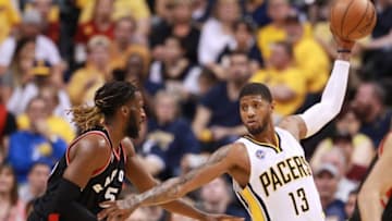 Apr 23, 2016; Indianapolis, IN, USA; Indiana Pacers forward Paul George (13) is guarded by Toronto Raptors forward DeMarre Carroll (5) during the second half of game four of the first round of the 2016 NBA Playoffs at Bankers Life Fieldhouse. Indiana defeats Toronto 100-83. Mandatory Credit: Brian Spurlock-USA TODAY Sports