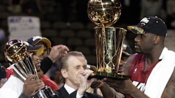 Dallas, UNITED STATES: Miami Heat head coach Pat Riley (C) holds the Larry O'Brian trophy with Dwyane Wade (L) and Shaquille O'Neal (R) after winning the NBA finals against the Dallas Mavericks in Game 6 at the American Airlines Center in Dallas 20 June 2006. The Heat won 95-92 to take the best-of-seven series 4-2. AFP PHOTO/Jeff HAYNES (Photo credit should read JEFF HAYNES/AFP/Getty Images)