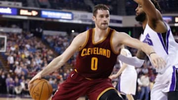 Jan 11, 2015; Sacramento, CA, USA; Cleveland Cavaliers forward Kevin Love (0) drives in against Sacramento Kings forward Derrick Williams (13) during the second quarter at Sleep Train Arena. Mandatory Credit: Kelley L Cox-USA TODAY Sports