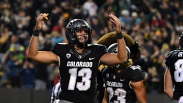 Nov 19, 2016; Boulder, CO, USA; Colorado Buffaloes quarterback Sefo Liufau (13) celebrates a rushing touchdown by running back Phillip Lindsay (23) (background) in the fourth quarter against the Washington State Cougars at Folsom Field. The Buffaloes defeated the Cougars 38-24. Mandatory Credit: Ron Chenoy-USA TODAY Sports