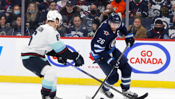 Feb 17, 2022; Winnipeg, Manitoba, CAN; Seattle Kraken defenseman Adam Larsson (6) checks Winnipeg Jets right wing Blake Wheeler (26) in the second period at Canada Life Centre. Mandatory Credit: James Carey Lauder-USA TODAY Sports