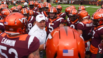 BLACKSBURG, VA - SEPTEMBER 14: Head coach Justin Fuente of the Virginia Tech Hokies speaks to his team inside a huddle prior to the game against the Furman Paladins at Lane Stadium on September 14, 2019 in Blacksburg, Virginia. (Photo by Michael Shroyer/Getty Images)