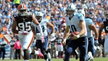 Oct 5, 2014; Nashville, TN, USA; Tennessee Titans quarterback Jake Locker (10) rushes for a touchdown against the Cleveland Browns during the first half at LP Field. Mandatory Credit: Jim Brown-USA TODAY Sports