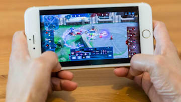 HONG KONG, HONG KONG - SEPTEMBER 11: A teenager plays Wangzhe Rongyao, variably known in English unofficial translations as King of Glory, a multiplayer online battle arena developed and published by Tencent Games for the iOS and Android mobile platforms, exclusively for the Chinese market, in Hong Kong, Hong Kong on September 11, 2018. (Photo by Yu Chun Christopher Wong/S3studio/Getty Images)