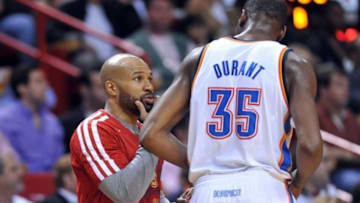 Jan 29, 2014; Miami, FL, USA; Oklahoma City Thunder point guard Derek Fisher (left) talks with teammate small forward Kevin Durant (right) during the second half against the Miami Heat at American Airlines Arena. Mandatory Credit: Steve Mitchell-USA TODAY Sports