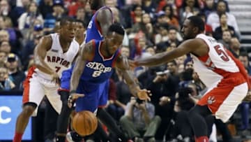 Nov 9, 2014; Toronto, Ontario, CAN; Philadelphia 76ers guard Tony Wroten (8) bobbles the ball as Toronto Raptors guard Kyle Lowry (7) and forward Patrick Patterson (54) defend during the first half at the Air Canada Centre. Mandatory Credit: John E. Sokolowski-USA TODAY Sports