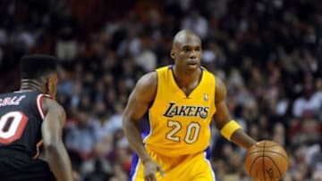 Jan 23, 2014; Miami, FL, USA; Los Angeles Lakers shooting guard Jodie Meeks (20) dribbles as Miami Heat point guard Norris Cole (30) defends during the first half at American Airlines Arena. Mandatory Credit: Steve Mitchell-USA TODAY Sports