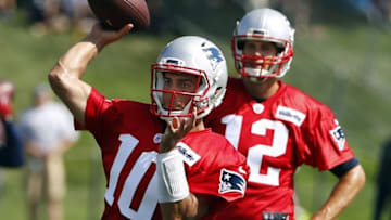 Jul 28, 2016; Foxboro, MA, USA; New England Patriots quarterback Jimmy Garoppolo (10) throws as quarterback Tom Brady (12) looks on during training camp at Gillette Stadium. Mandatory Credit: Winslow Townson-USA TODAY Sports