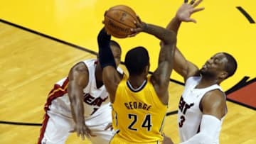 May 30, 2014; Miami, FL, USA; Indiana Pacers forward Paul George (24) is defended by Miami Heat guard Dwyane Wade (3) and center Chris Bosh (1) during game six of the Eastern Conference Finals of the 2014 NBA Playoffs at American Airlines Arena. Mandatory Credit: Robert Mayer-USA TODAY Sports