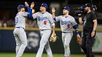 SEATTLE, WA - AUGUST 17: Manny Machado #8 of the Los Angeles Dodgers, Brian Dozier #6 of the Los Angeles Dodgers and Justin Turner #10 of the Los Angeles Dodgers celebrate after a game against the Seattle Mariners at Safeco Field on August 17, 2018 in Seattle, Washington. The Dodgers won the game 11-1. (Photo by Stephen Brashear/Getty Images)
