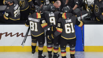 LAS VEGAS, NEVADA - DECEMBER 08: Cody Glass #9 of the Vegas Golden Knights is helped off the ice by teammates Jonathan Marchessault #81 and Mark Stone #61 after suffering an injury during the second period against the New York Rangers at T-Mobile Arena on December 08, 2019 in Las Vegas, Nevada. (Photo by David Becker/NHLI via Getty Images)