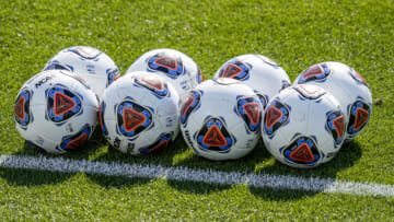 NCAA official Soccer Balls are lined up on the field (Credit: Jim Dedmon-USA TODAY Sports)