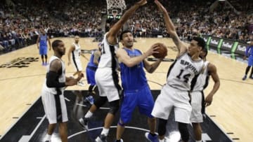 Nov 25, 2015; San Antonio, TX, USA; Dallas Mavericks center Zaza Pachulia (27) shoots the ball as San Antonio Spurs power forward Tim Duncan (21) and guard Danny Green (14) defend during the first half at AT&T Center. Mandatory Credit: Soobum Im-USA TODAY Sports