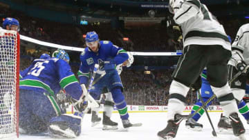 VANCOUVER, BC - OCTOBER 9: Jacob Markstrom #25 of the Vancouver Canucks and Christopher Tanev #8 of the Vancouver Canucks and Alex Iafallo #19 of the Los Angeles Kings watch a loose puck during their NHL game at Rogers Arena October 9, 2019 in Vancouver, British Columbia, Canada. (Photo by Jeff Vinnick/NHLI via Getty Images)"n