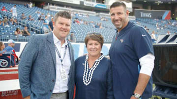 NASHVILLE, TN - AUGUST 18: Executive Vice President/General Manager Jon Robinson, Controlling Owner and Co-Chairman,Board of Directors Amy Adams Strunk, and head coach Mike Vrabel pose for a photo on the sideline durin warms up prior to a pre-season game against the Tampa Bay Buccaneers at Nissan Stadium on August 18, 2018 in Nashville, Tennessee. (Photo by Frederick Breedon/Getty Images)