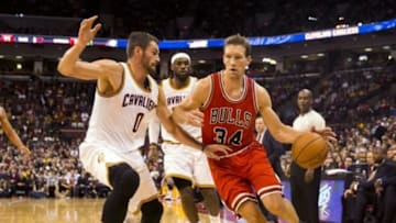 Oct 20, 2014; Columbus, OH, USA; Chicago Bulls forward Mike Dunleavy (34) dives around Cleveland Cavaliers forward Kevin Love (0) at Value City Arena. Cleveland won the game 107-98. Mandatory Credit: Greg Bartram-USA TODAY Sports