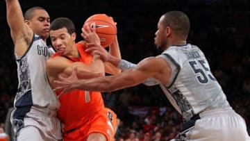 Mar 15, 2013; New York, NY, USA; Syracuse Orange guard Michael Carter-Williams (1) drives on Georgetown Hoyas guard Markel Starks (5) and guard Jabril Trawick (55) during the second half of a semifinal game of the Big East tournament at Madison Square Garden. Syracuse won 58-55 in overtime. Mandatory Credit: Brad Penner-USA TODAY Sports