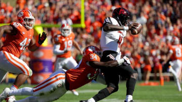 CLEMSON, SC - NOVEMBER 03: Kendall Joseph #34 of the Clemson Tigers tries to stop Jawon Pass #4 of the Louisville Cardinals during their game at Clemson Memorial Stadium on November 3, 2018 in Clemson, South Carolina. (Photo by Streeter Lecka/Getty Images)
