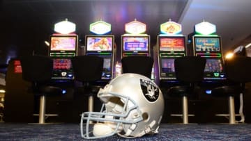 May 11, 2016; Las Vegas, NV, USA; General view of Oakland Raiders helmet and slot machines at the McCarran International Airport. Raiders owner Mark Davis (not pictured) has pledged $500 million toward building a 65,000-seat domed stadium in Las Vegas at a total cost of $1.4 billion. NFL commissioner Roger Goodell (not pictured) said Davis can explore his options in Las Vegas but would require 24 of 32 owners to approve the move. Mandatory Credit: Kirby Lee-USA TODAY Sports