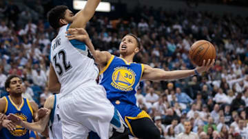 Mar 21, 2016; Minneapolis, MN, USA; Golden State Warriors guard Stephen Curry (30) shoots in the second quarter against the Minnesota Timberwolves center Karl-Anthony Towns (32) at Target Center. Mandatory Credit: Brad Rempel-USA TODAY Sports