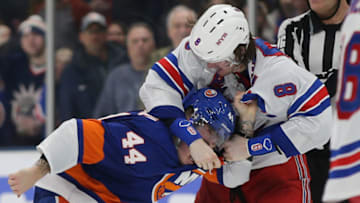 Feb 25, 2020; Uniondale, New York, USA; New York Islanders center Jean-Gabriel Pageau (44) and New York Rangers defenseman Jacob Trouba (8) fight during the third period at Nassau Veterans Memorial Coliseum. Mandatory Credit: Brad Penner-USA TODAY Sports