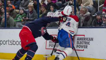 Nov 29, 2023; Columbus, Ohio, USA; Columbus Blue Jackets defenseman Ivan Provorov (9) checks Montreal Canadiens center Nick Suzuki (14) along the boards in the first period at Nationwide Arena. Mandatory Credit: Aaron Doster-USA TODAY Sports