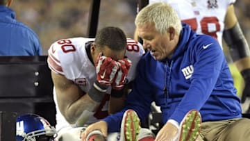 Oct 12, 2014; Philadelphia, PA, USA; New York Giants wide receiver Victor Cruz (80) with trainer Byron Hansen as he is carted off the field after an injury during the third quarter against the Philadelphia Eagles at Lincoln Financial Field. Mandatory Credit: Eric Hartline-USA TODAY Sports