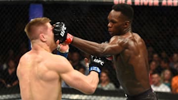 GLENDALE, AZ - APRIL 14: (R-L) Israel Adesanya of Nigeria punches Marvin Vettori of Italy in their middleweight fight during the UFC Fight Night event at the Gila Rivera Arena on April 14, 2018 in Glendale, Arizona. (Photo by Josh Hedges/Zuffa LLC/Zuffa LLC via Getty Images)