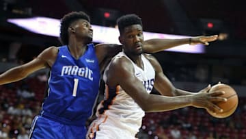 LAS VEGAS, NV - JULY 09: Deandre Ayton #22 of the Phoenix Suns is guarded by Jonathan Isaac #1 of the Orlando Magic during the 2018 NBA Summer League at the Thomas & Mack Center on July 9, 2018 in Las Vegas, Nevada. The Suns defeated the Magic 71-53. NOTE TO USER: User expressly acknowledges and agrees that, by downloading and or using this photograph, User is consenting to the terms and conditions of the Getty Images License Agreement. (Photo by Ethan Miller/Getty Images)