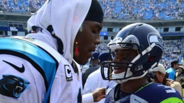 Sep 8, 2013; Charlotte, NC, USA; Carolina Panthers quarterback Cam Newton (1) talks with Seattle Seahawks quarterback Russell Wilson (3) after the game. The Seahawks defeated the Panthers 12-7 at Bank of America Stadium. Mandatory Credit: Bob Donnan-USA TODAY Sports