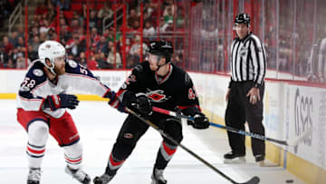 RALEIGH, NC - MARCH 30: Joakim Nordstrom #42 of the Carolina Hurricanes battles for a loose puck along the boards with David Savard #58 of the Columbus Blue Jackets during an NHL game on March 30, 2017 at PNC Arena in Raleigh, North Carolina. (Photo by Gregg Forwerck/NHLI via Getty Images)