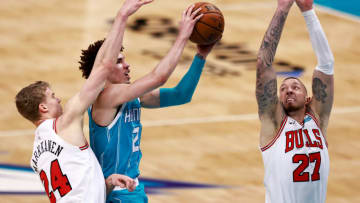 CHARLOTTE, NORTH CAROLINA - MAY 06: LaMelo Ball #2 of the Charlotte Hornets drives between Lauri Markkanen #24 and Daniel Theis #27 of the Chicago Bulls during the second quarter of their game at Spectrum Center on May 06, 2021 in Charlotte, North Carolina. NOTE TO USER: User expressly acknowledges and agrees that, by downloading and or using this photograph, User is consenting to the terms and conditions of the Getty Images License Agreement. (Photo by Grant Halverson/Getty Images)