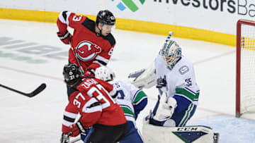 Feb 28, 2022; Newark, New Jersey, USA; Vancouver Canucks goaltender Thatcher Demko (35) makes a save in front of New Jersey Devils left wing Jesper Bratt (63) during the third period at Prudential Center. Mandatory Credit: Vincent Carchietta-USA TODAY Sports