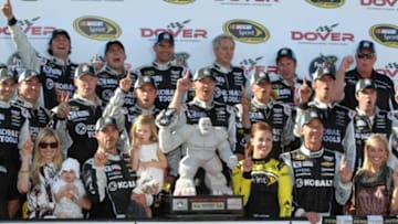 Jun 1, 2014; Dover, DE, USA; NASCAR Sprint Cup driver Jimmie Johnson (48) and team celebrate in victory lane after winning the FedEx 400 at Dover International Speedway. Mandatory Credit: Matthew O