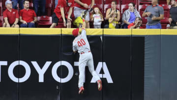 CINCINNATI, OHIO - SEPTEMBER 04: Adam Haseley #40 of the Philadelphia Phillies reaches up above the outfield wall to catch the ball hit by the Freddy Galvis #3 of the Cincinnati Reds at Great American Ball Park on September 04, 2019 in Cincinnati, Ohio. (Photo by Andy Lyons/Getty Images)