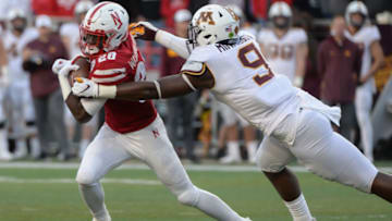 LINCOLN, NE - OCTOBER 20: Defensive lineman Esezi Otomewo #9 of the Minnesota Golden Gophers tackles running back Maurice Washington #28 of the Nebraska Cornhuskers in the second half at Memorial Stadium on October 20, 2018 in Lincoln, Nebraska. (Photo by Steven Branscombe/Getty Images)