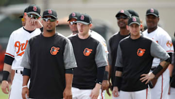 SARASOTA, FL - FEBRUARY 23: Baltimore Orioles players look on while wearing Stoneman Douglas High School baseball caps to honor the 17 people killed earlier this month during a mass shooting prior to a Grapefruit League spring training game against the Tampa Bay Rays at Ed Smith Stadium on February 23, 2018 in Sarasota, Florida. (Photo by Joe Robbins/Getty Images)