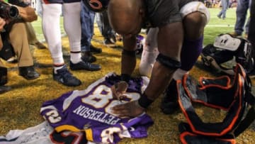 Dec 9, 2012; Minneapolis, MN, USA; Minnesota Vikings running back Adrian Peterson (28) signs a jersey for Chicago Bears wide receiver Brandon Marshall (not pictured) following the game at the Metrodome. The Vikings defeated the Bears 21-14. Mandatory Credit: Brace Hemmelgarn-USA TODAY Sports