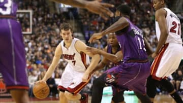 Mar 13, 2015; Toronto, Ontario, CAN; Miami Heat point guard Goran Dragic (7) goes to the basket against Toronto Raptors point guard Kyle Lowry (7) at Air Canada Centre. Mandatory Credit: Tom Szczerbowski-USA TODAY Sports