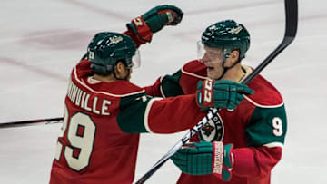 Dec 9, 2014; Saint Paul, MN, USA; Minnesota Wild forward Mikko Koivu (9) celebrates his goal with forward Jason Pominville (29) during the third period against the New York Islanders at Xcel Energy Center. The Wild defeated the Islanders 5-4. Mandatory Credit: Brace Hemmelgarn-USA TODAY Sports