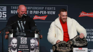 NEW YORK, NY - NOVEMBER 10: Conor McGregor of Ireland takes Eddie Alvarez's lightweight belt during the UFC 205 press conference at The Theater at Madison Square Garden on November 10, 2016 in New York City. (Photo by Michael Reaves/Getty Images)