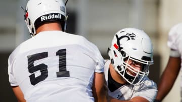 Cincinnati Bearcats offensive lineman Vincent McConnell and Lorenz Metz during a drill at practice. The Enquirer.