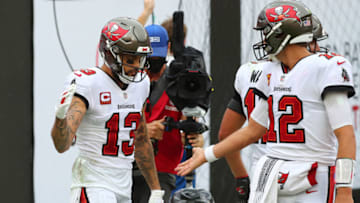 Oct 4, 2020; Tampa, Florida, USA; Tampa Bay Buccaneers wide receiver Mike Evans (13) celebrates a touchdown with quarterback Tom Brady (12) against the Los Angeles Chargers in the second quarter of a NFL game at Raymond James Stadium. Mandatory Credit: Kim Klement-USA TODAY Sports
