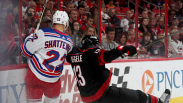 RALEIGH, NC - OCTOBER 07: Warren Foegele #13 of the Carolina Hurricanes is upended by Kevin Shattenkirk #22 of the New York Rangers during an NHL game on October 7, 2018 at PNC Arena in Raleigh, North Carolina. (Photo by Gregg Forwerck/NHLI via Getty Images)